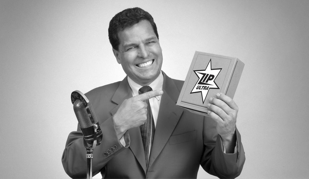 black and white image of man smiling and pointing to graphic design on box