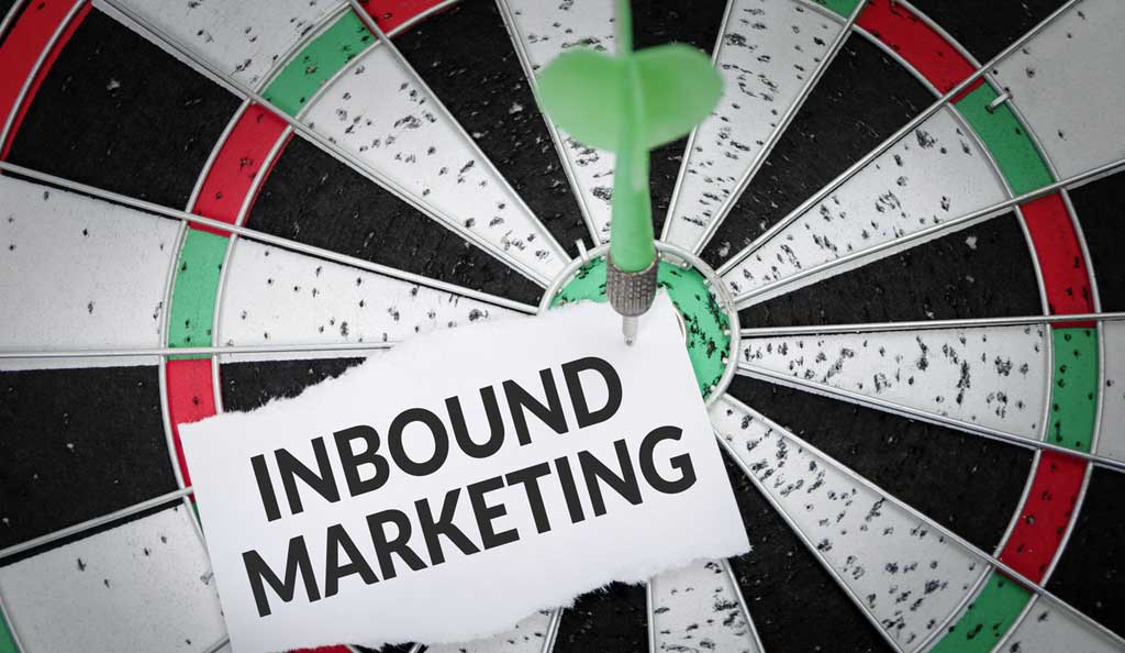 inbound marketing sign stuck to a dart board