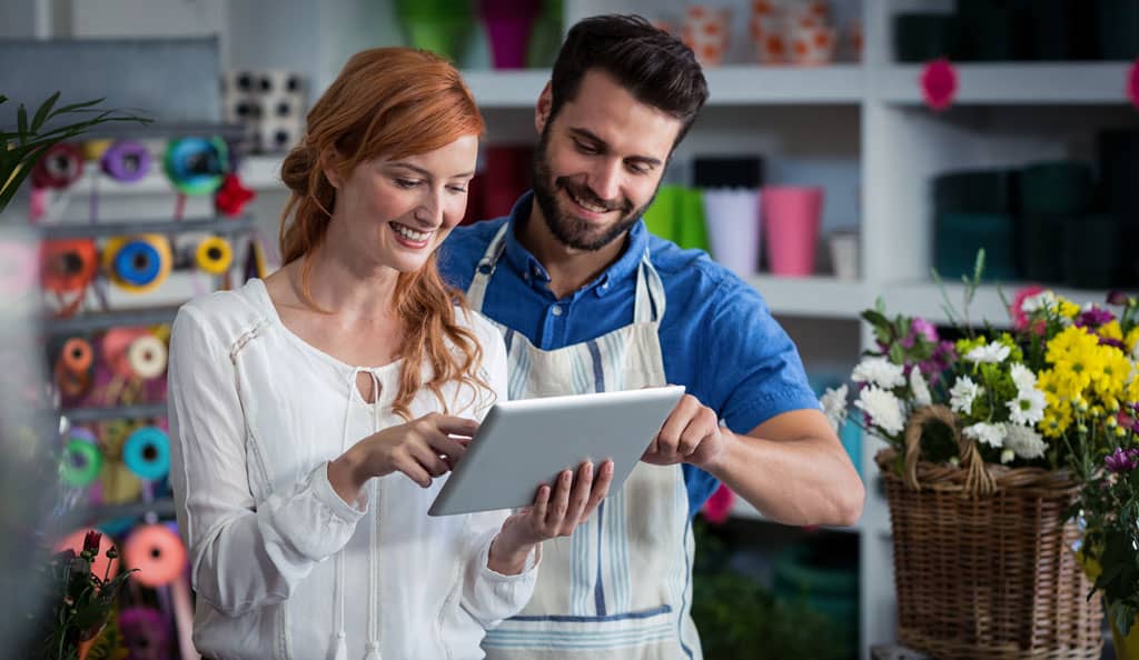 web designer showing business owner his new website on an iPad