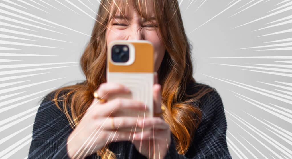 a woman smiling while filming a short form video