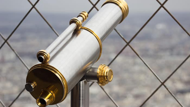 a telescope at the top of a building overlooking a city