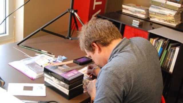 a man working at a desk full of papers and books