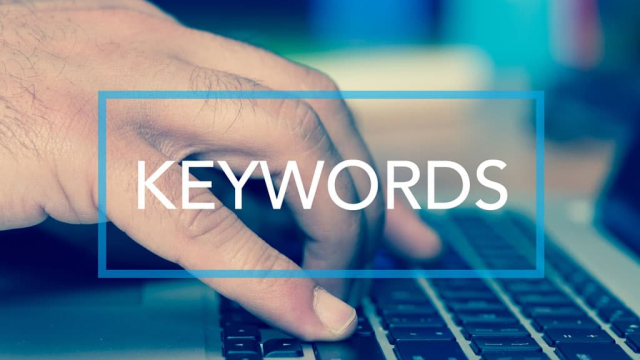 close up of man's hand typing keywords on a laptop keyboard