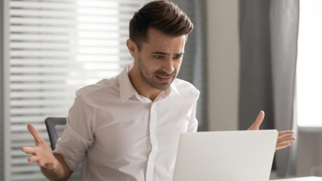 frustrated man from a poor user interface on his laptop
