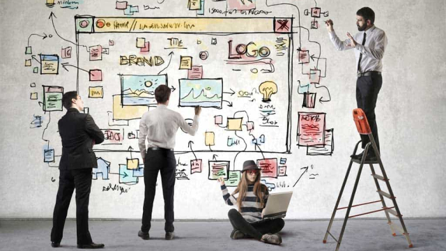Four web designers drawing out a website homepage