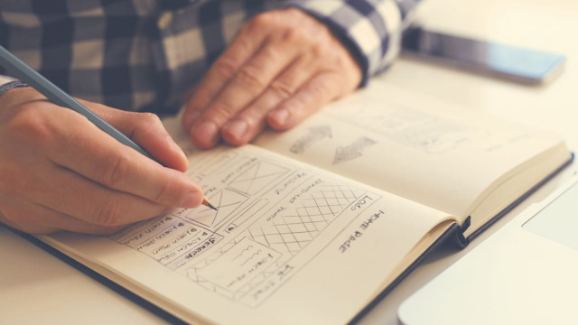 man drawing a user interface concept for a web design